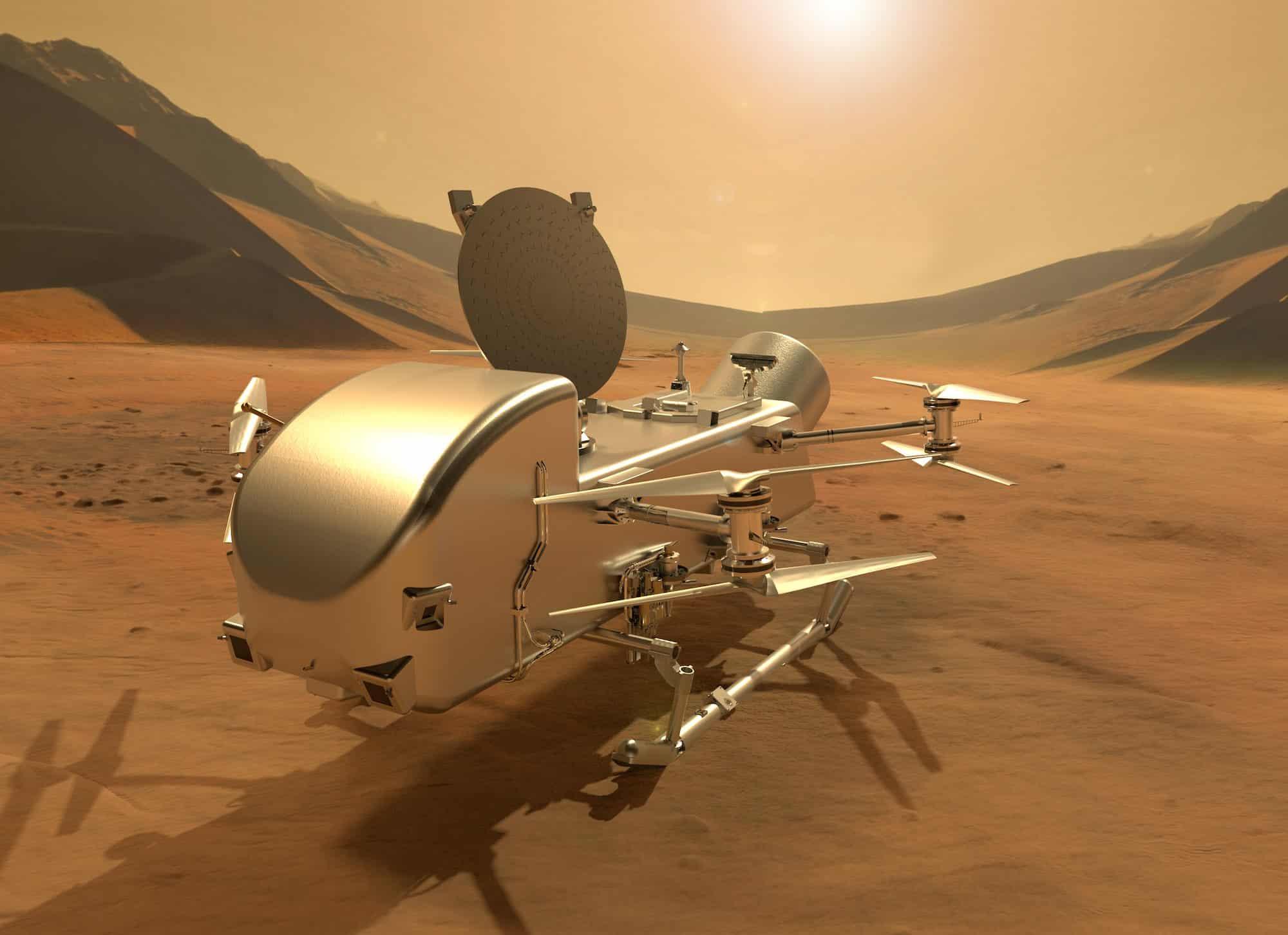 Vue d'artiste du drone Dragonfly posé à la surface de Titan. L'appareil déploie ses antennes et ses instruments scientifiques dans un paysage désertique aux teintes orangées, sous le ciel brumeux de la lune de Saturne. © NASA/Johns Hopkins APL/Steve Gribben